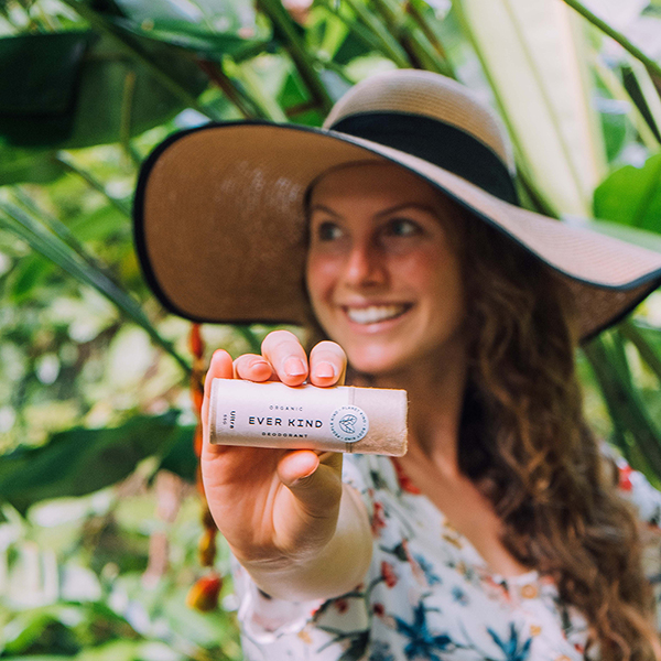 Women in nature holding Everkind natural deodorant for women.